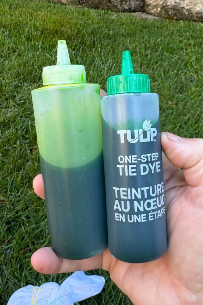 Two bottles of green tie-dye used to make Frankenstein Halloween tie-dye shirts, one bright green and one darker forest green for layering.